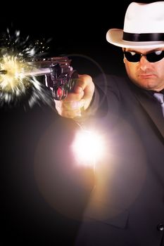 View of a dark suit gangster man firing a gun.