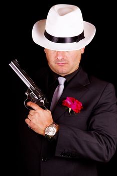 View of a dark suit gangster man holding a gun.