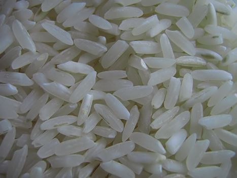 A photograph of uncooked white rice detailing its texture.
