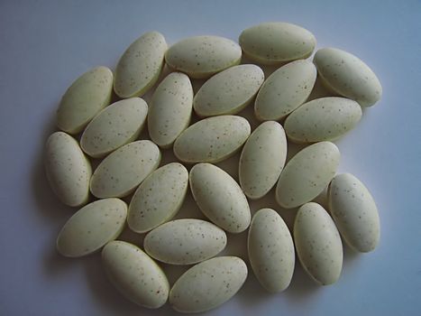A photograph of pills detailing their shape.