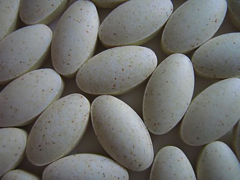 A photograph of pills detailing their shape.