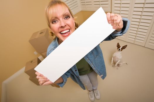 Excited Woman and Doggy with Blank Sign Near Moving Boxes in Empty Room Taken with Extreme Wide Angle Lens.
