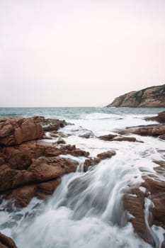 Beautiful seascape. Sea and rock at the sunset. Nature composition.