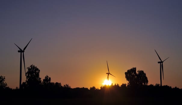 wind turbine during sunset in summer time