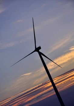 Wind turbine farm over sunset