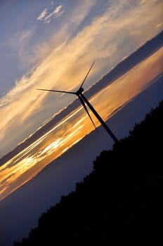 Wind turbine farm over sunset