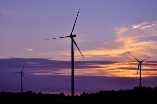 Wind turbine farm over sunset