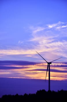 Wind turbine farm over sunset