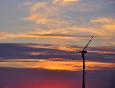 Wind turbine farm over sunset