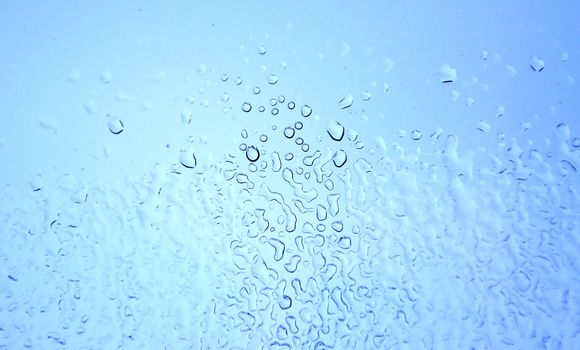 An image of raindrops at the window