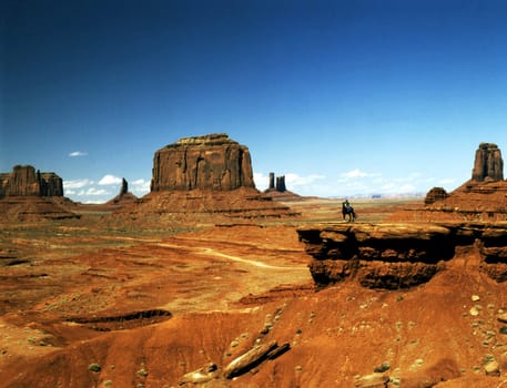 Monument Valley with Navajo girl on horse back, Arizona