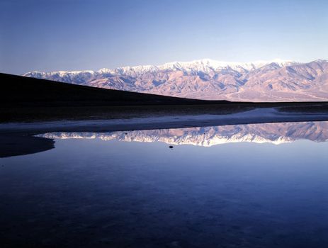 Reflection of mountain range in Badwater