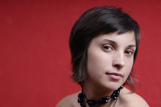 young woman portrait on red background