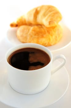 Breaksfast of black coffee and fresh croissants