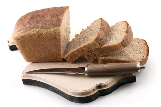 Knife and the cut bread on a board on a white background