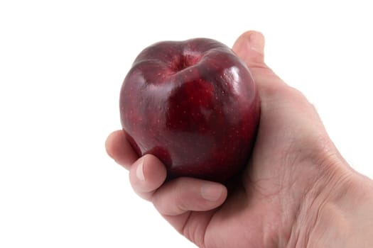 Red apple in a hand on a white background