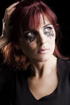 Portrait of a Beautiful fashion young woman with makeup over a black background
