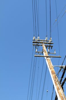 Telegraph pole over blue sky