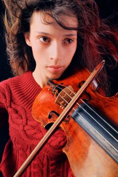 A young woman playing a violin with expression