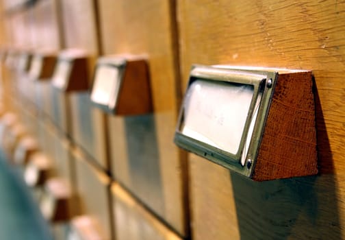 Closeup of row of drawers from library card catalogue