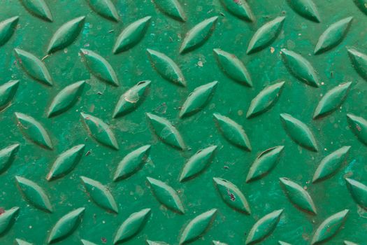 Diamond metal painted green on piece of background