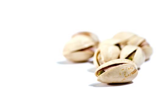 closeup image of pistachios on white background