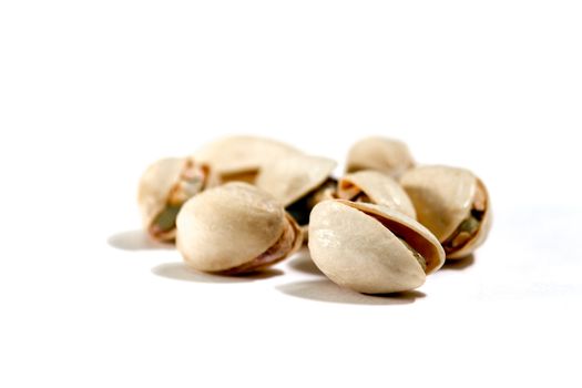 closeup image of pistachios on white background