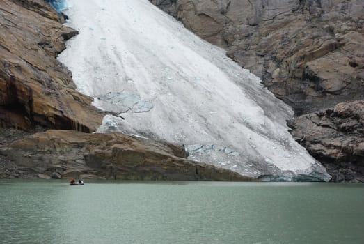 Mountain glacier Briksdale and  lake full of ice water Norway, Europe 