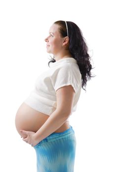 Pregnant happy young woman in a dress by an isolated white background
