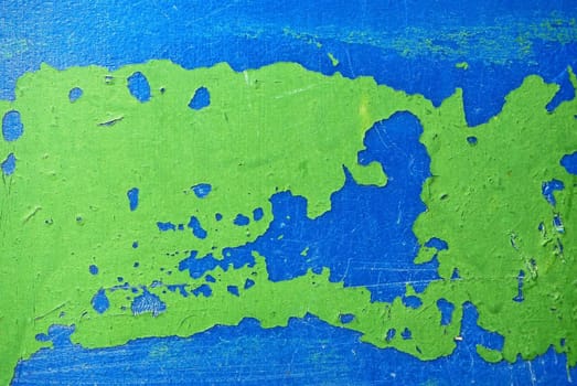 Blue plastic surface with traces of green paint