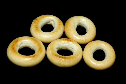 Five bread-rings on black placed as olimpic rings