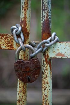 Old rusty gates closed wiyh chain and  padlock