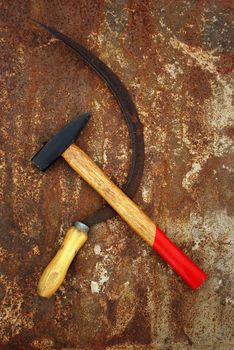 The soviet symbol sickle and hammer on rusty  background