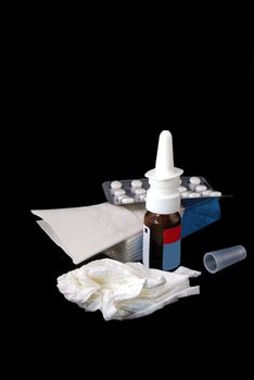 Medicine nasal spray, drugs and package of  handkerchiefes on black background