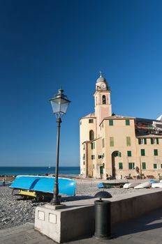 beach and church in Camogli, famous small town in Mediterranean sea, Italy