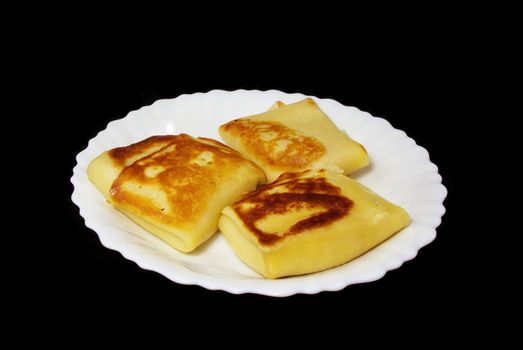 Traditional russian festal day delicacy pancake with caviar isolated on black background