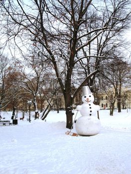 Big snowman in park in winter