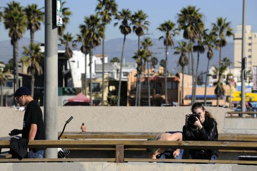 The girl the photographer photographs from a pier in Los Angeles.