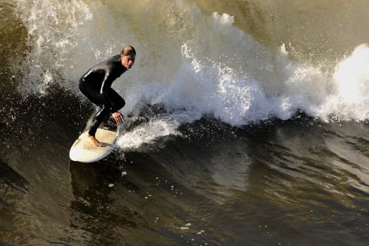 Surfer on a board slides on a wave.