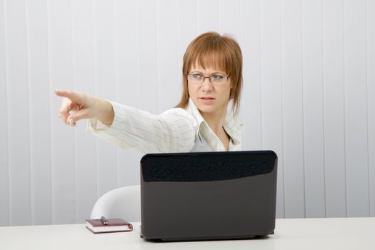 angry young woman chief kicks slave. Office scene