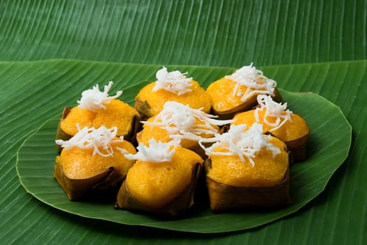 dessert thai sweet sugar palm cake with coconut on banana leaf background