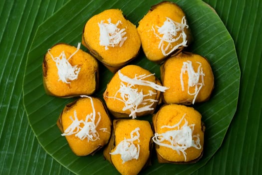 Topview of dessert thai sweet sugar palm cake with coconut on banana leaf background