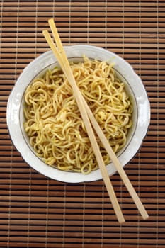 Bowl of instant noodles over white background