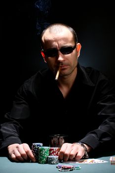 Portrait of a poker player over black background