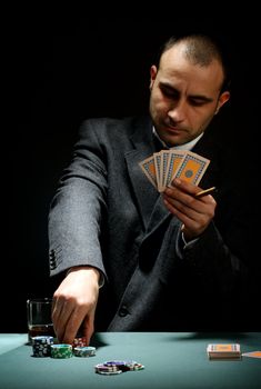 Portrait of a poker player over black background