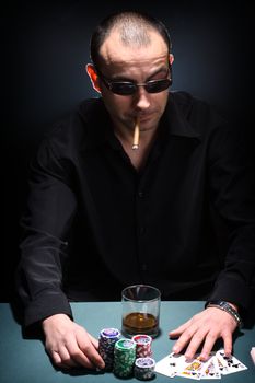 Portrait of a poker player over black background