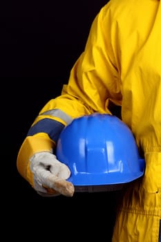 man holding blue helmet over black  background