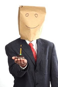 Businessman with paper bag on his head celebrating a birthday 