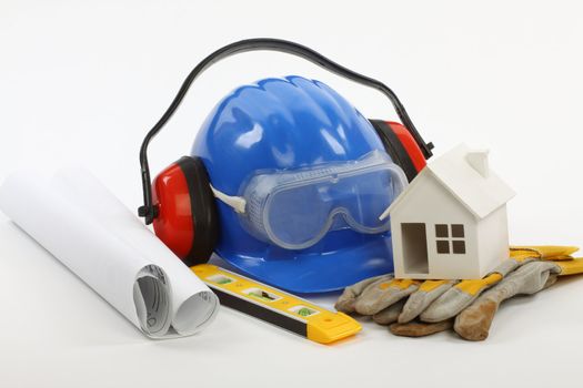 construction concept- house model, industrial tools and protective gear 