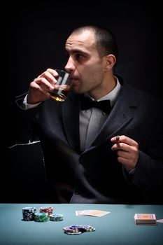 Portrait of a poker player over black background